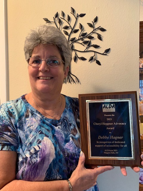 Debbie holding award